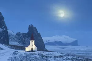 Guy Edwardes Collection: Vik i Myrdal church in winter, with full moon, Iceland. January 2015