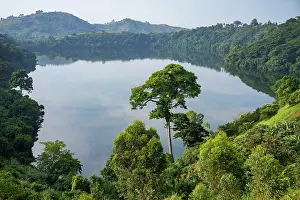 Volcanic crater lake surrounded by forest, near Kibale, Uganda. March, 2023
