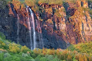 Nordic Countries Prints: Waterfall cascading over cliffs during midnight sun, Nordland, Norway. June, 2022
