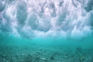 Wave breaking over the rubble zone close to the reef crest of a coral reef. Baa Atoll, Maldives. Indian Ocean