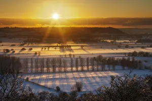 High Angle Shot Prints: Winter sunset over the Somerset Levels from Walton Hill on a misty evening with snow on the ground