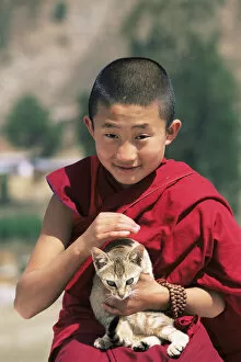 Young buddhist monk holding cat, Punakha Dzong, Central Bhutan 2001