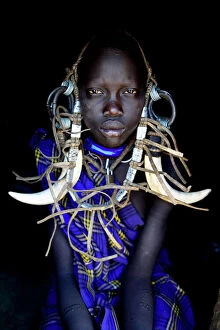 Black Background Gallery: Young girl in traditional dress. Mursi tribe, Mago National Park. Omo Valley, Ethiopia